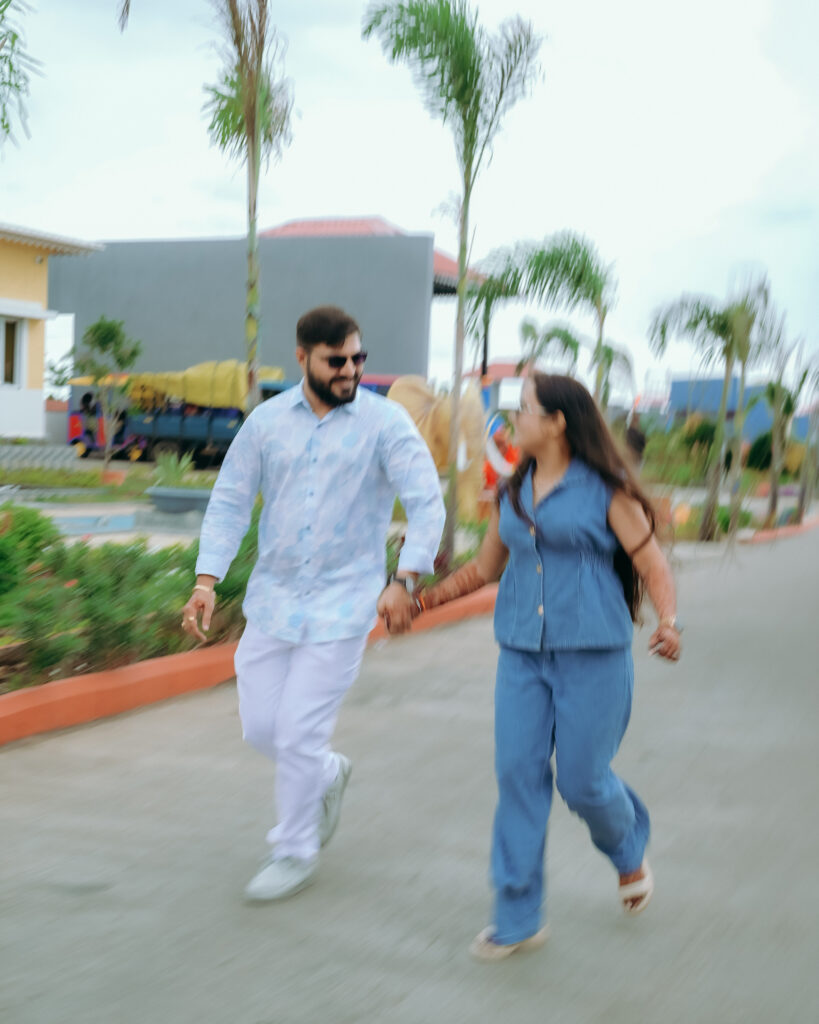 Candid wedding photography moment of a couple running hand in hand at Chitra’s City Side Resort, Solapur