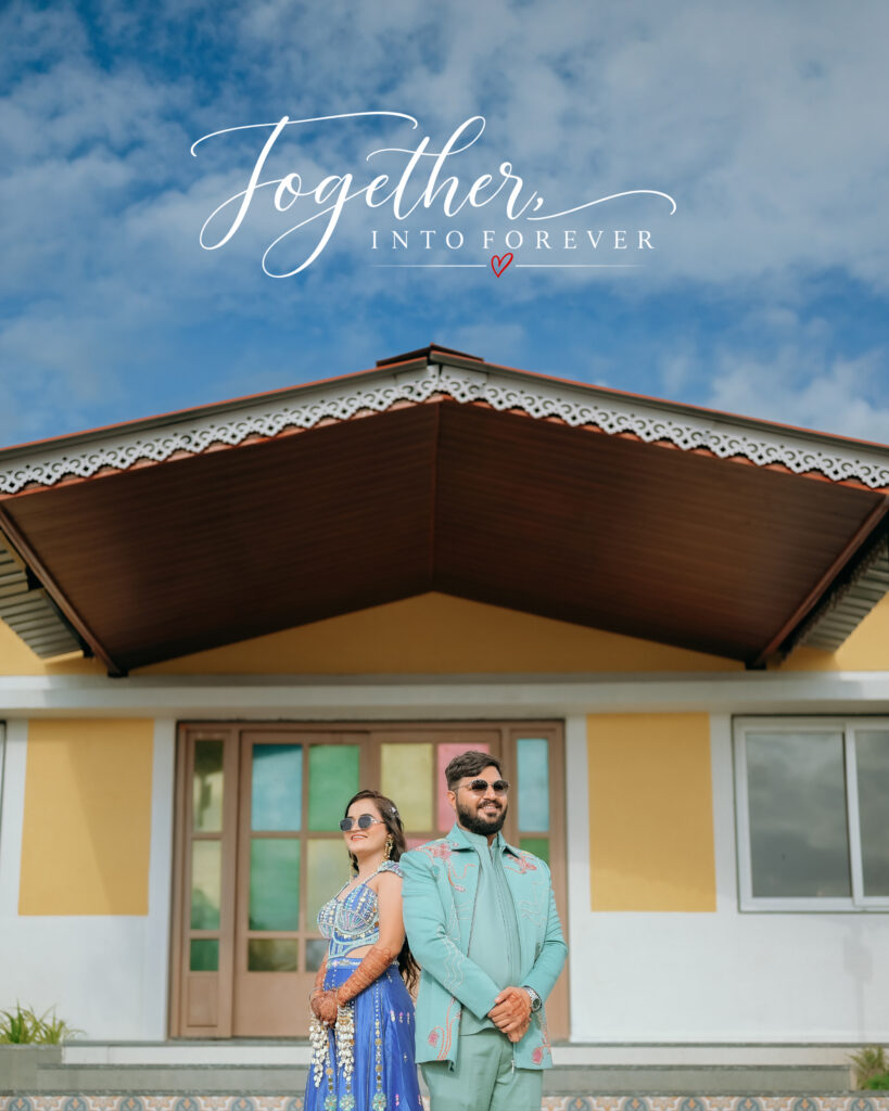 Couple standing back to back in front of a yellow resort building at Chitra’s City Side Resort, Solapur