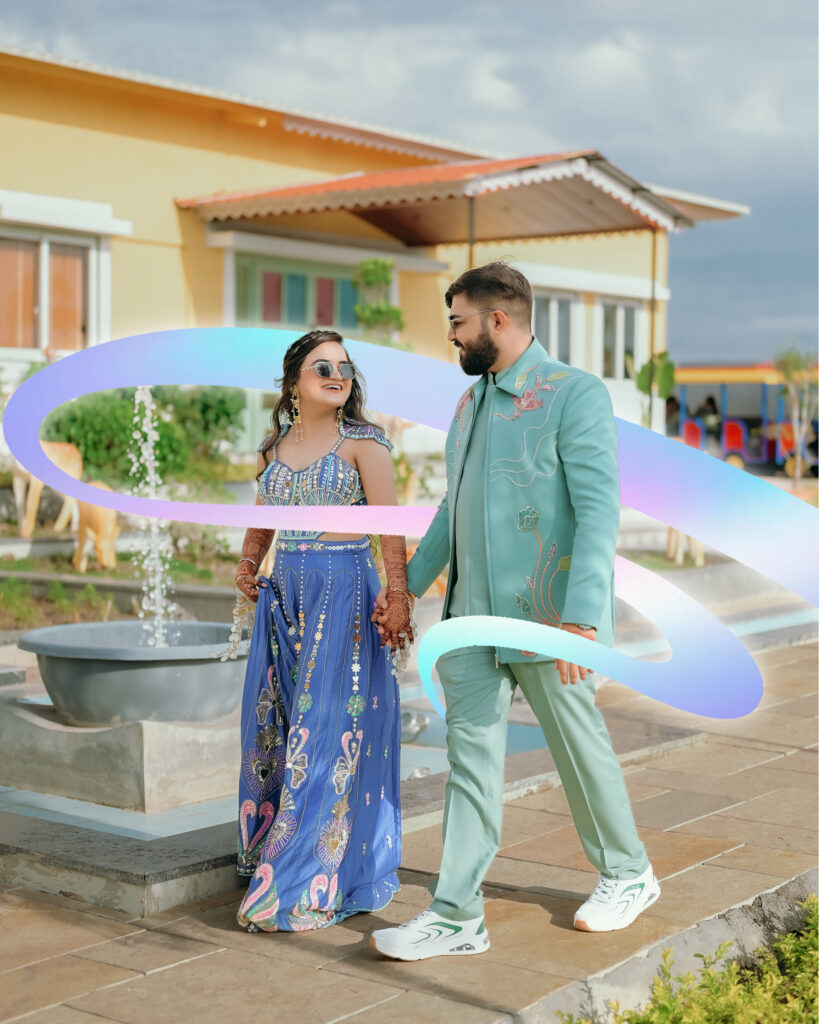Couple holding hands and smiling as they walk past a fountain at Chitra’s City Side Resort, Solapur