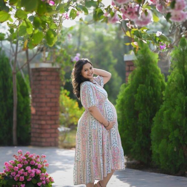 Couple maternity shoot in Solapur with husband holding baby bump
